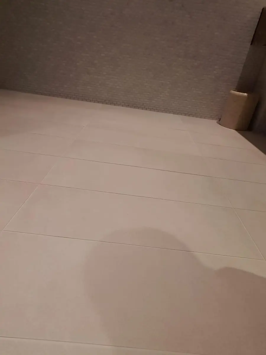 Clean gym shower floor and drainage area in a London fitness facility after professional disinfection